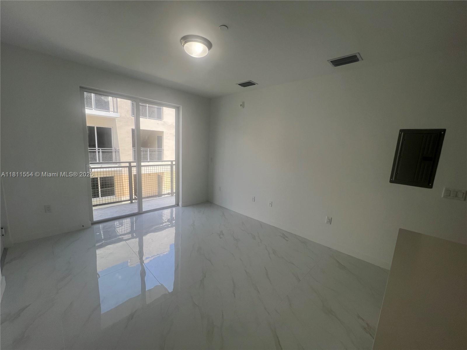 1010 Southwest 69th Avenue, Unit 212 Miami, FL 33144 - Photo 16 of 30 a view of an empty room with a window