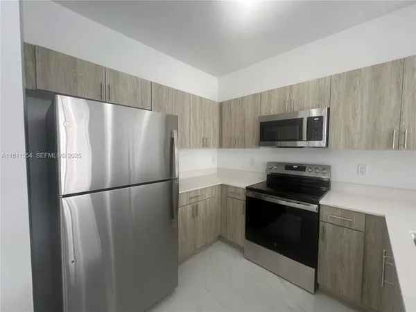 a view of a bathroom with a glass door and a bathroom sink