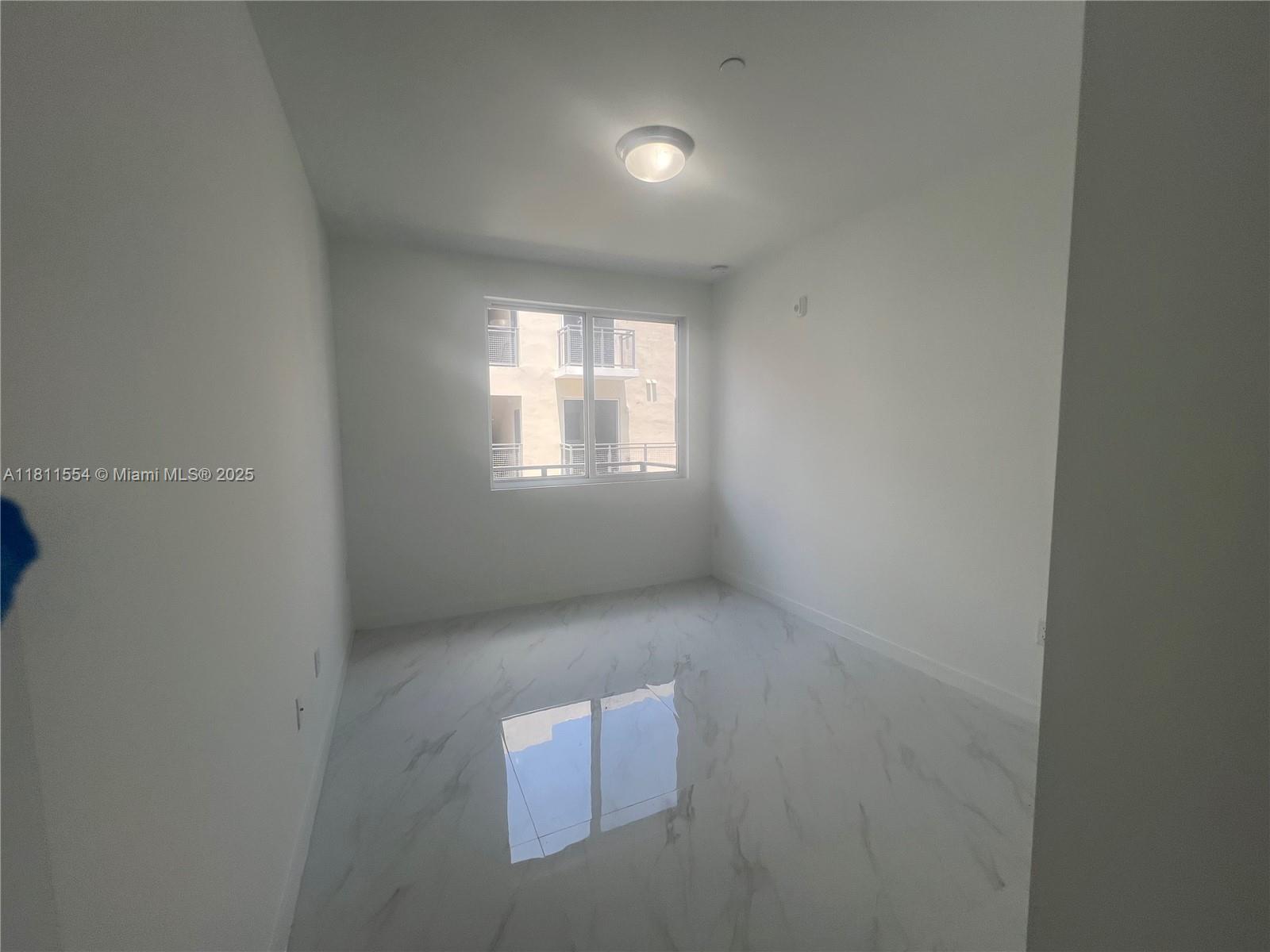 1010 Southwest 69th Avenue, Unit 212 Miami, FL 33144 - Photo 21 of 30 a view of an empty room with a window