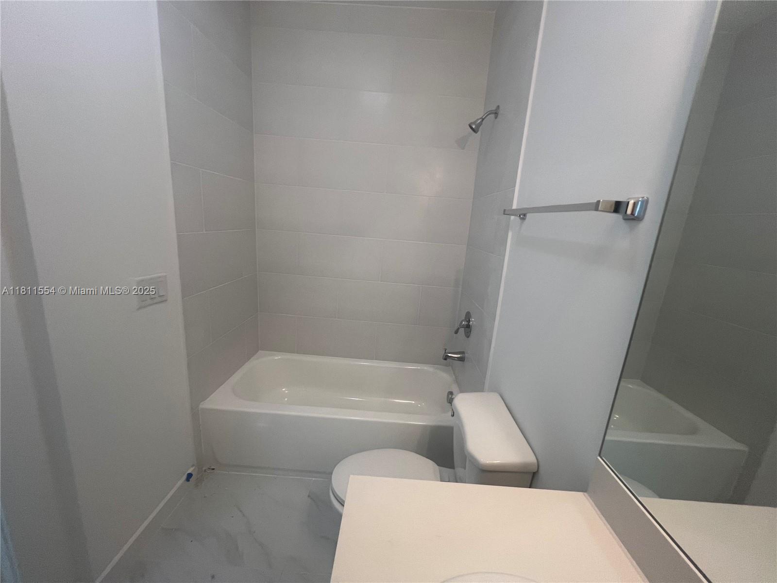 1010 Southwest 69th Avenue, Unit 212 Miami, FL 33144 - Photo 25 of 30 a bathroom with a toilet and bathtub