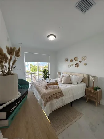 a bedroom with a bed and a window