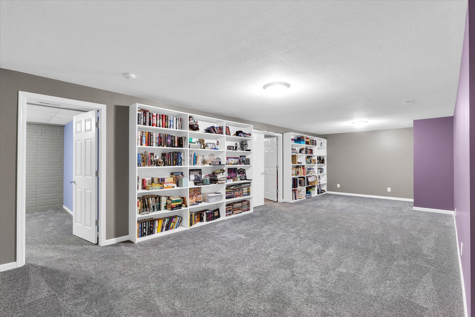 1330 West Ridge Lane Champaign, IL 61822 - Photo 17 of 39 a view of an empty room with a bookshelf and a refrigerator