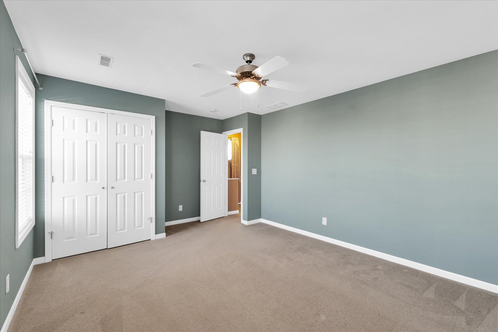 1330 West Ridge Lane Champaign, IL 61822 - Photo 21 of 39 an empty room with closet and a ceiling fan