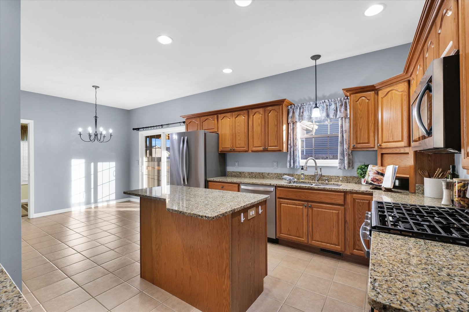 1330 West Ridge Lane Champaign, IL 61822 - Photo 5 of 39 a kitchen with stainless steel appliances granite countertop a sink stove and refrigerator