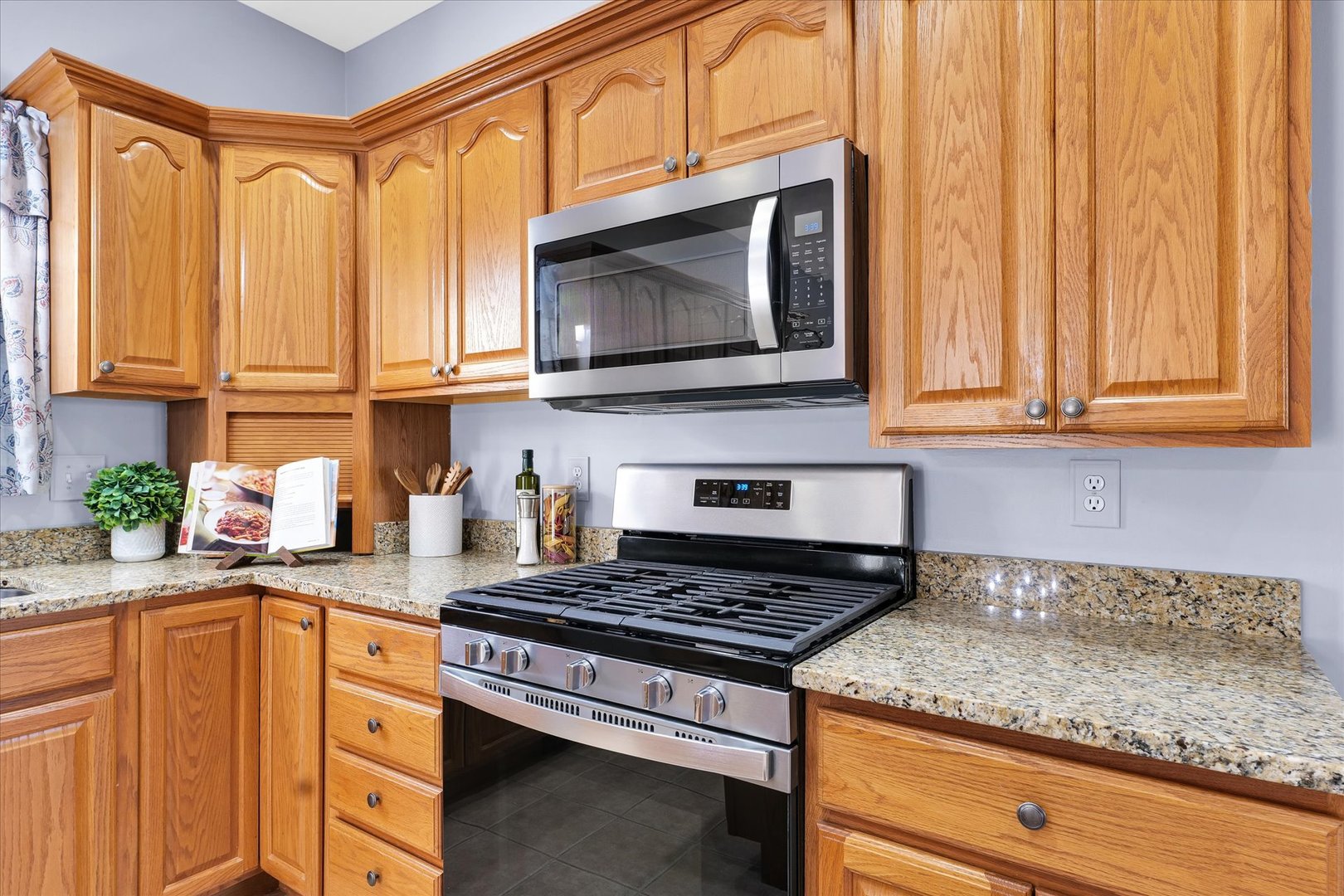 1330 West Ridge Lane Champaign, IL 61822 - Photo 6 of 39 a kitchen with stainless steel appliances granite countertop a stove a sink and a microwave