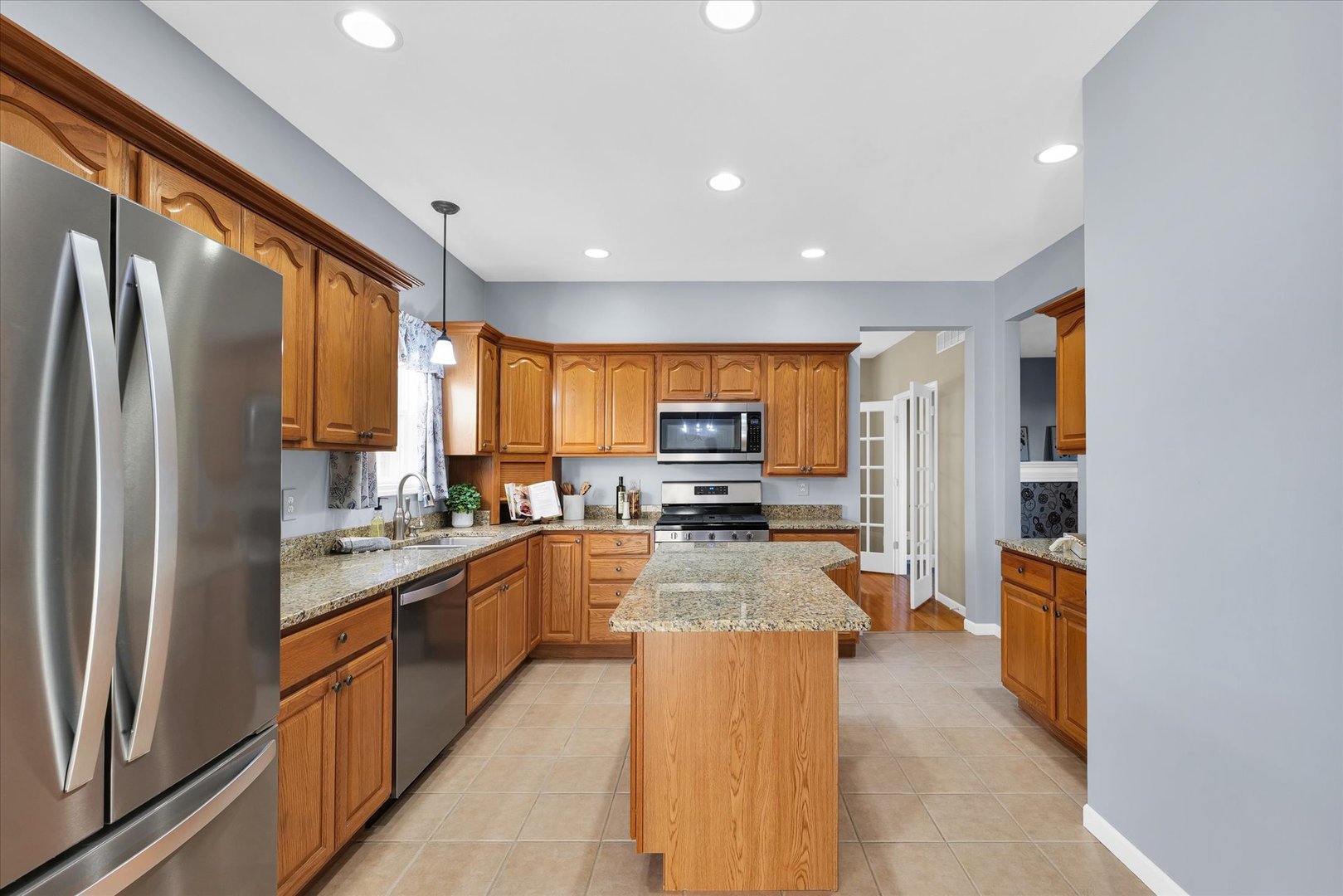 1330 West Ridge Lane Champaign, IL 61822 - Photo 7 of 39 a large kitchen with a large window and stainless steel appliances