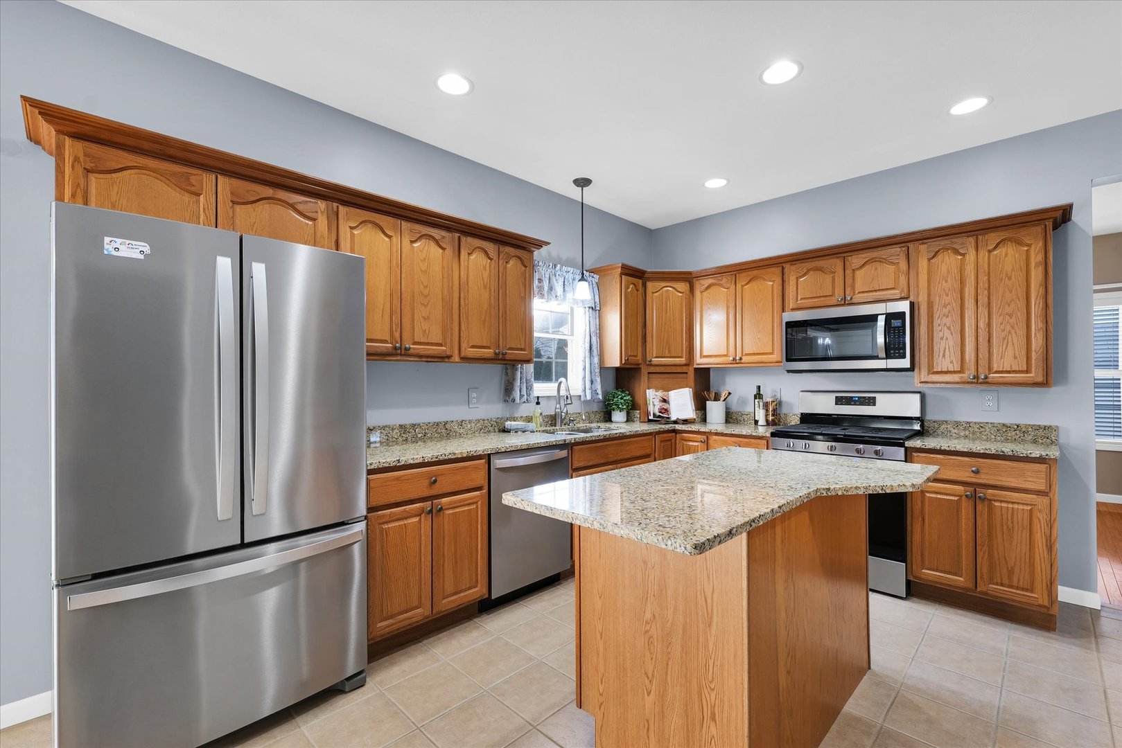 1330 West Ridge Lane Champaign, IL 61822 - Photo 8 of 39 a kitchen with stainless steel appliances granite countertop refrigerator stove microwave sink and cabinets