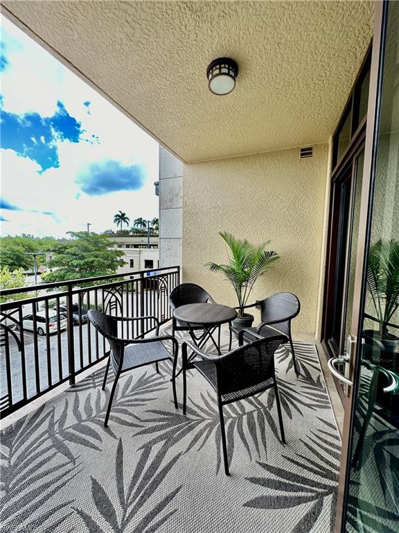 9115 Strada Place, Unit 5211 Naples, FL 34108 - Photo 12 of 31 a view of a chairs and table in the balcony