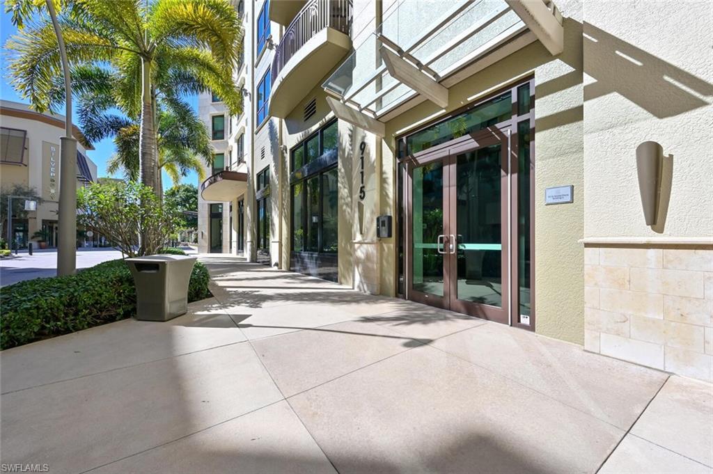 9115 Strada Place, Unit 5211 Naples, FL 34108 - Photo 25 of 31 a view of a building with a tree