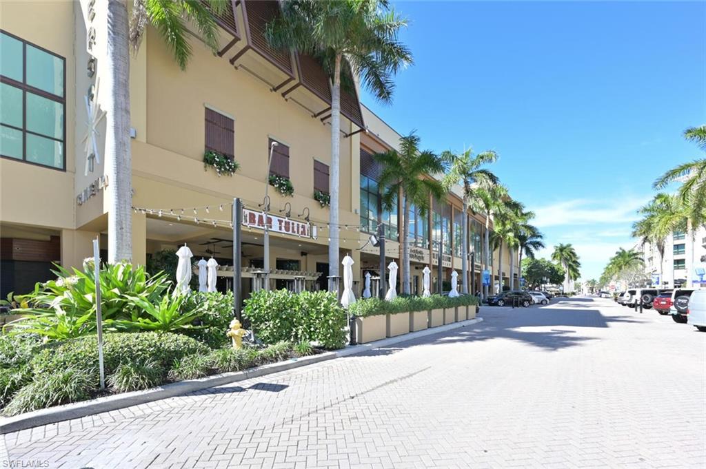 9115 Strada Place, Unit 5211 Naples, FL 34108 - Photo 27 of 31 a front view of a building with palm trees