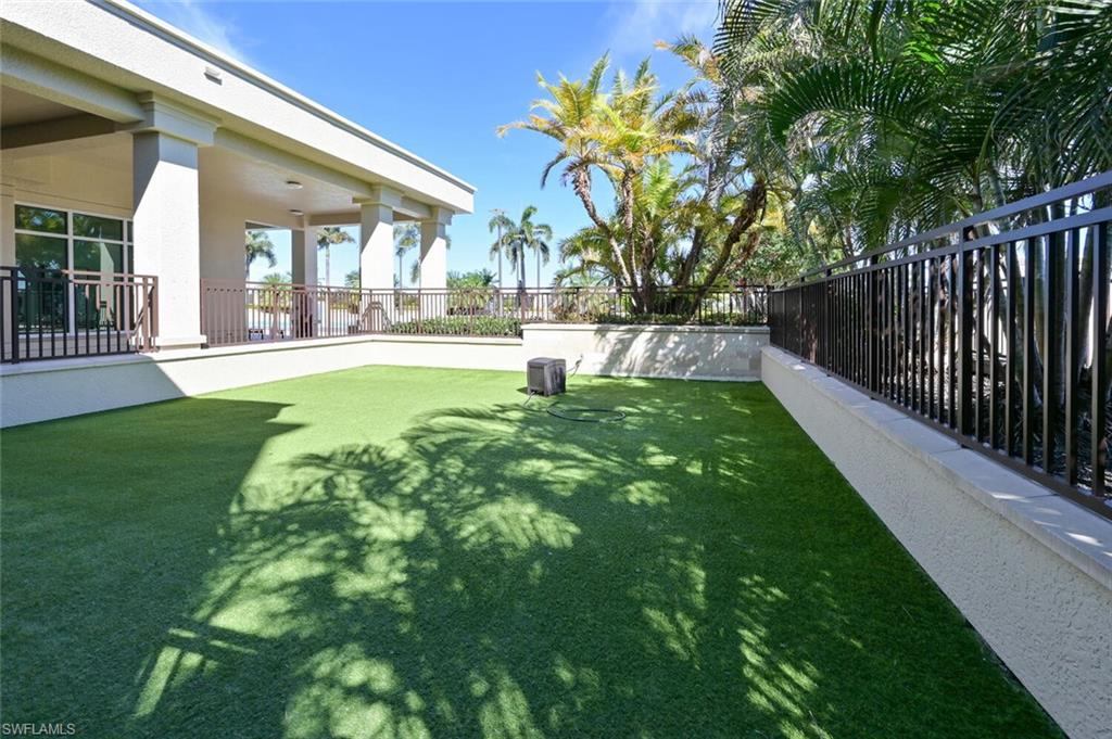9115 Strada Place, Unit 5211 Naples, FL 34108 - Photo 31 of 31 a swimming pool with outdoor seating and yard
