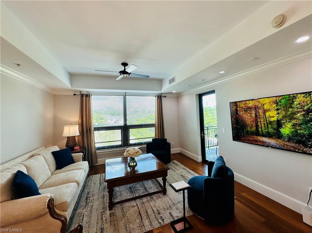9115 Strada Place, Unit 5211 Naples, FL 34108 - Photo 4 of 31 a living room with furniture and a flat screen tv