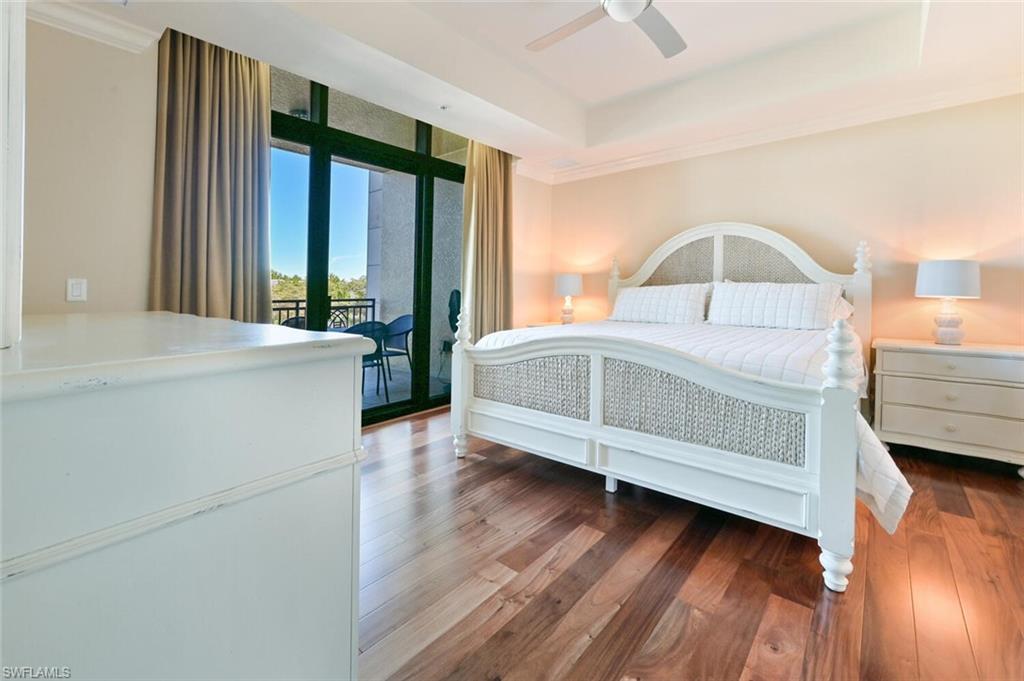 9115 Strada Place, Unit 5211 Naples, FL 34108 - Photo 10 of 31 a bedroom with a bed and a large window