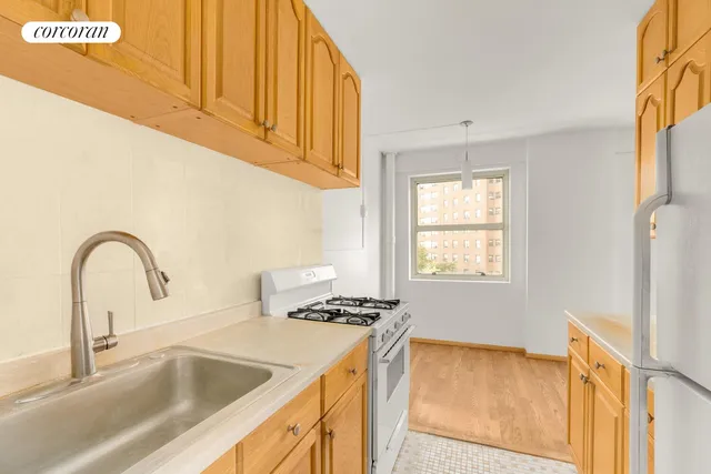 a view of an empty room with a kitchen