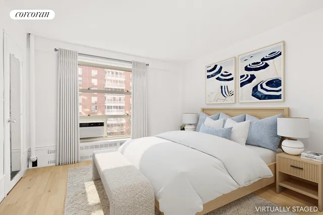 a bedroom with a large bed and a potted plant