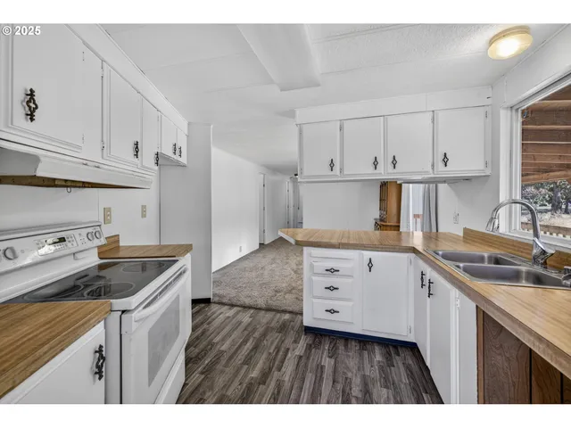 a kitchen that has a sink and cabinets