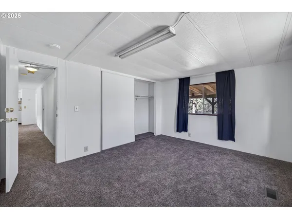 a view of an empty room and a window