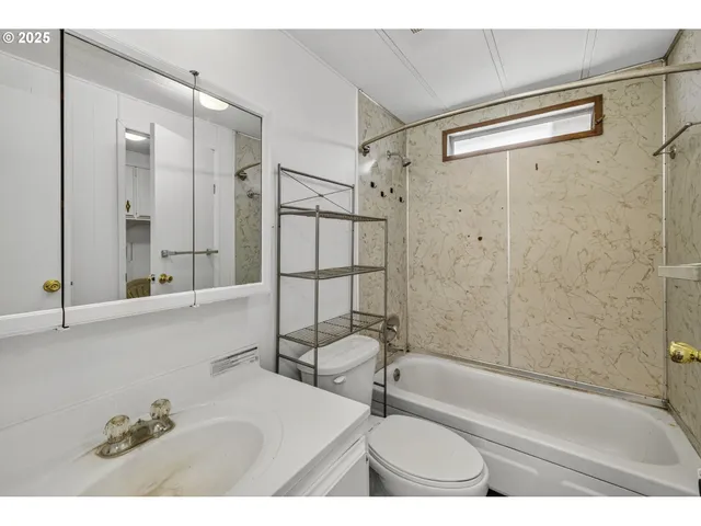 a bathroom with a tub a sink and a shower
