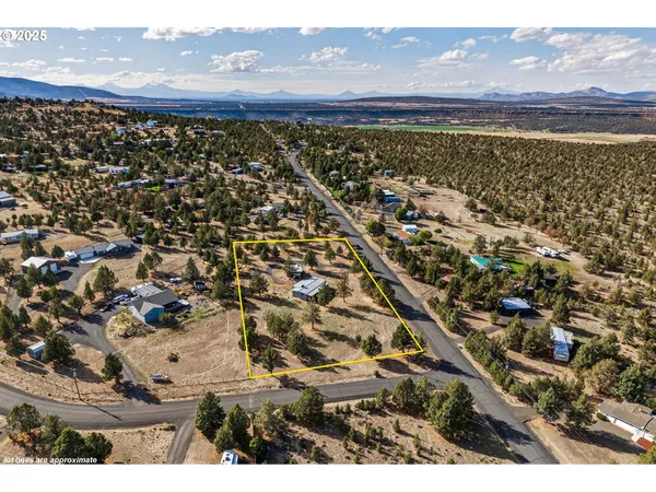 an aerial view of a house with a mountain