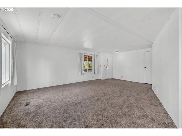 a view of an empty room and a window