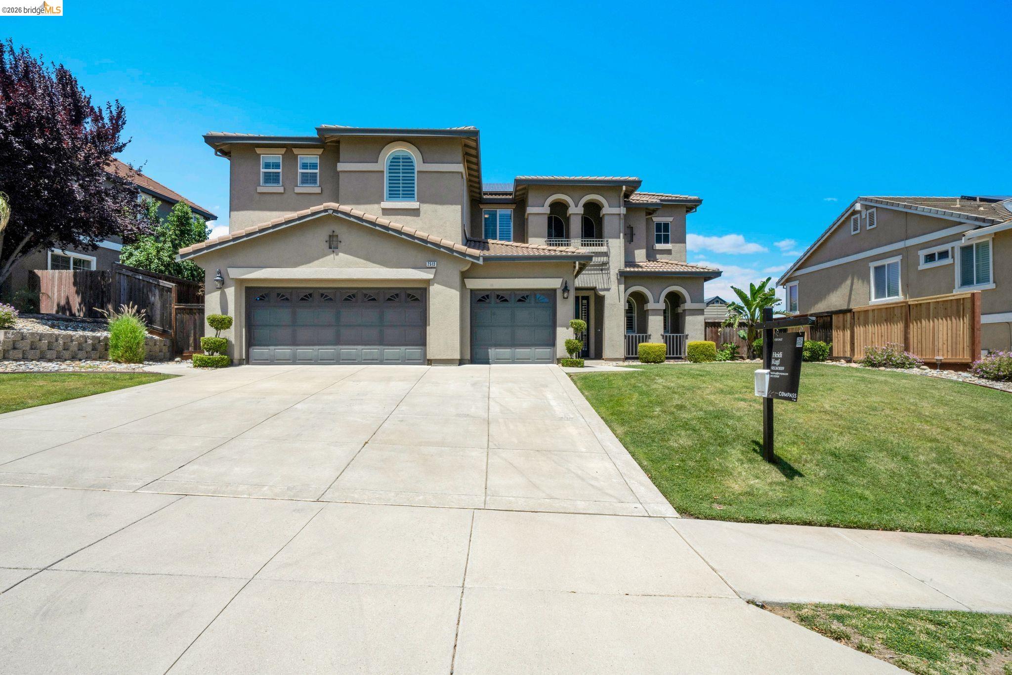 2513 Winged Foot Road Brentwood, CA 94513 - Photo 41 of 45 Stucco exterior featuring dual arched entryways, a concrete driveway, and a two-car garage