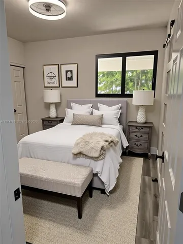 a bedroom with a bed and window