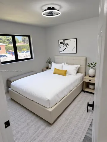 a bedroom with a bed and window