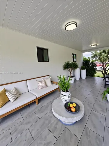 a living room with furniture and a potted plant