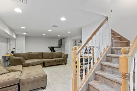 a living room with furniture and stairs