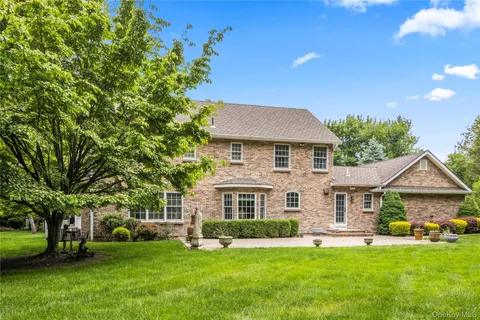 a front view of a house with a garden and yard