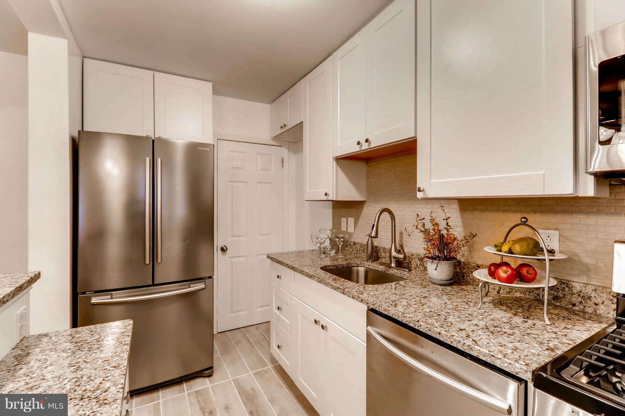 8405 Kavanagh Road Baltimore, MD 21222 - Photo 13 of 30 a kitchen with stainless steel appliances granite countertop a refrigerator sink and cabinets