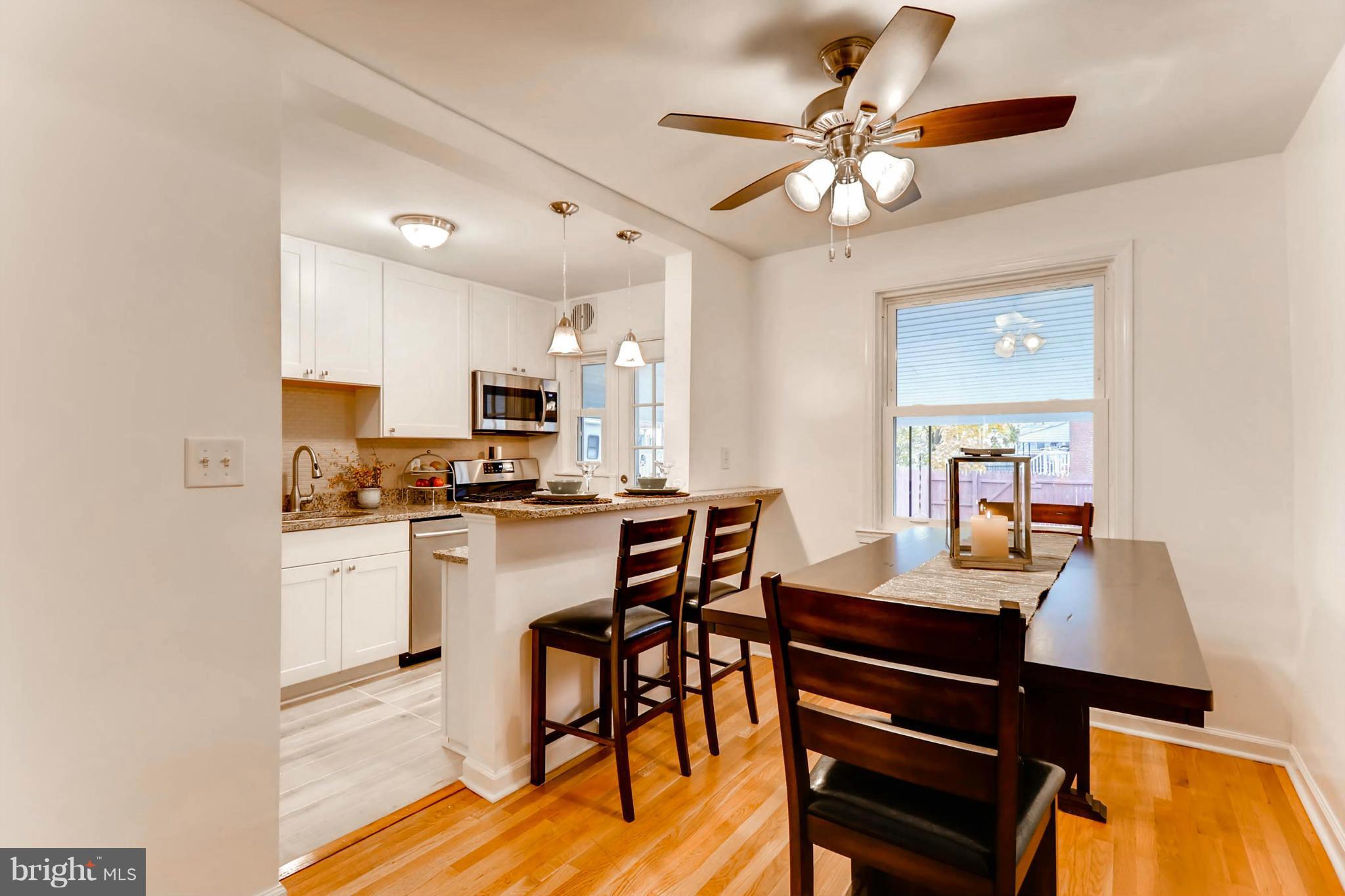8405 Kavanagh Road Baltimore, MD 21222 - Photo 15 of 30 a view of a dining room with furniture and a chandelier