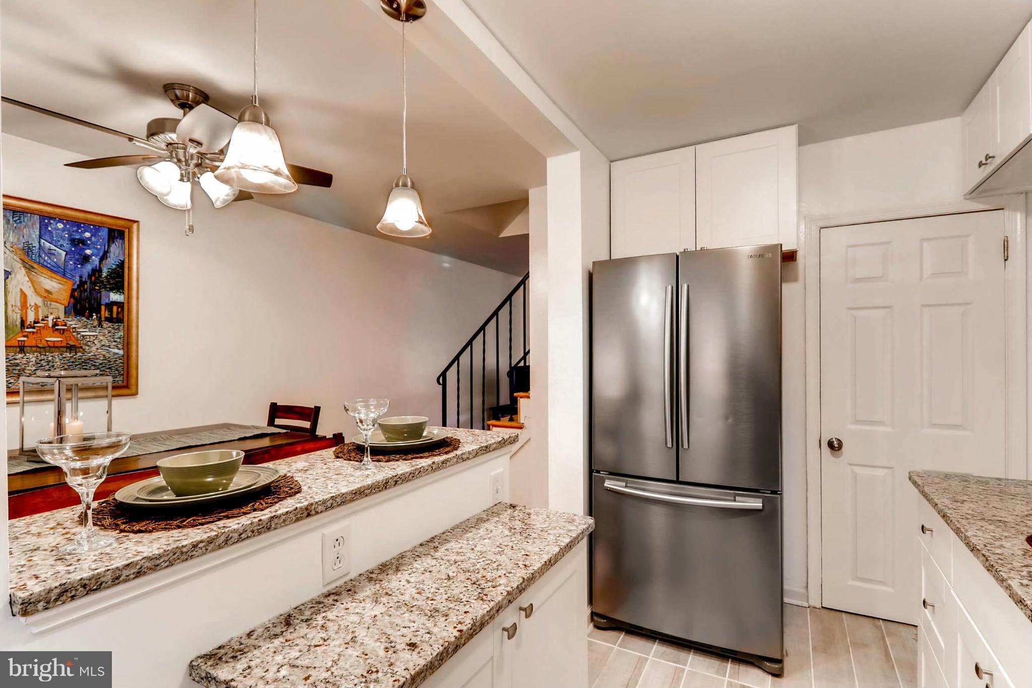 8405 Kavanagh Road Baltimore, MD 21222 - Photo 16 of 30 a kitchen with stainless steel appliances granite countertop a refrigerator a stove and a sink with dishwasher
