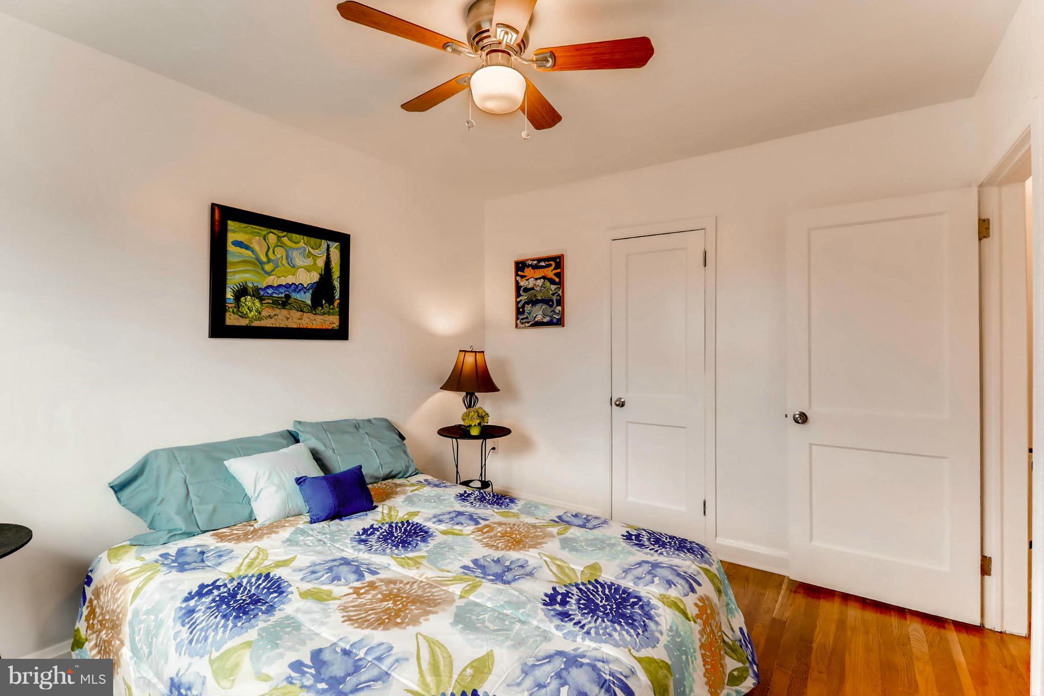 8405 Kavanagh Road Baltimore, MD 21222 - Photo 25 of 30 a bedroom with a bed and a chandelier