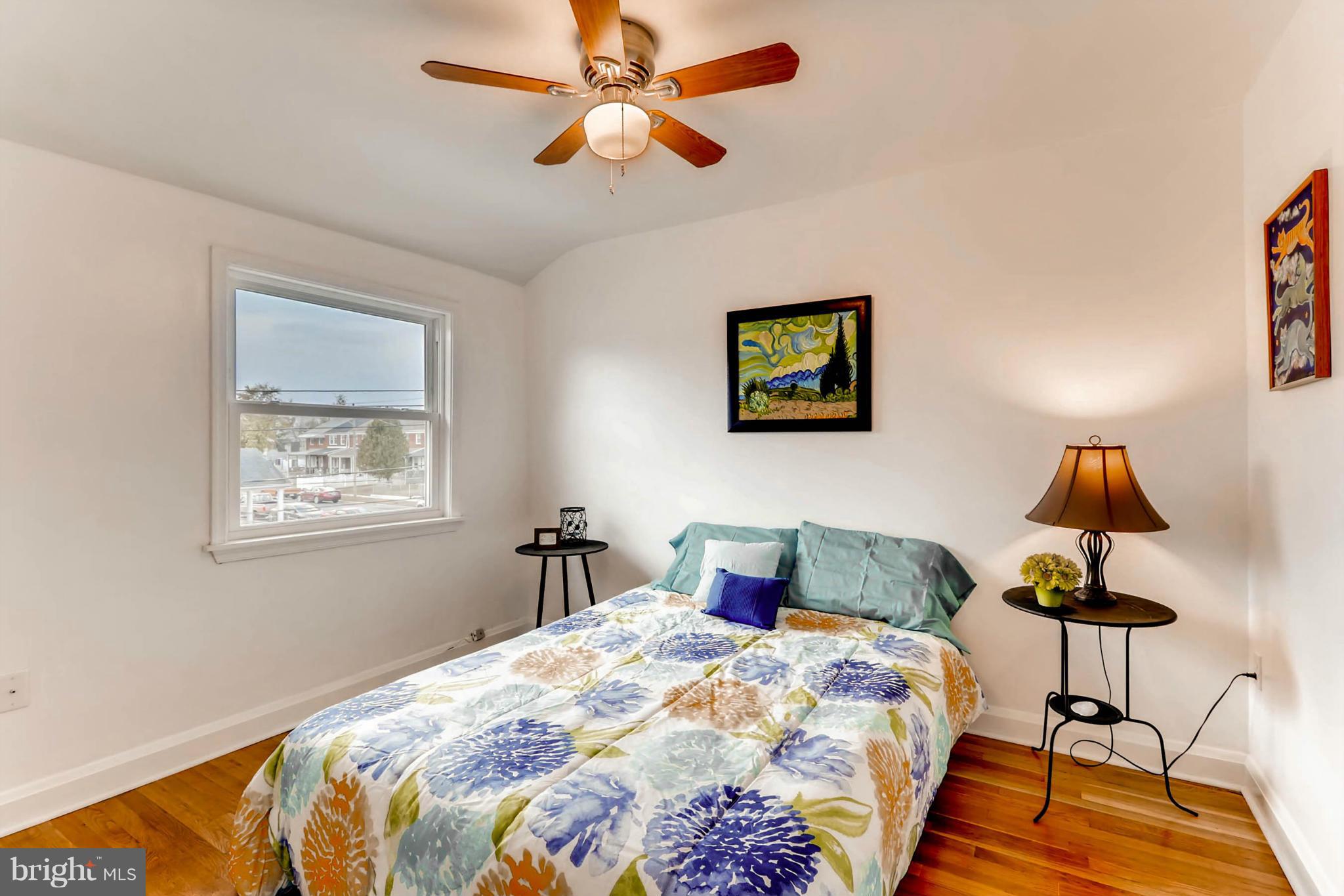 8405 Kavanagh Road Baltimore, MD 21222 - Photo 26 of 30 a bedroom with a bed and a lamp on dresser