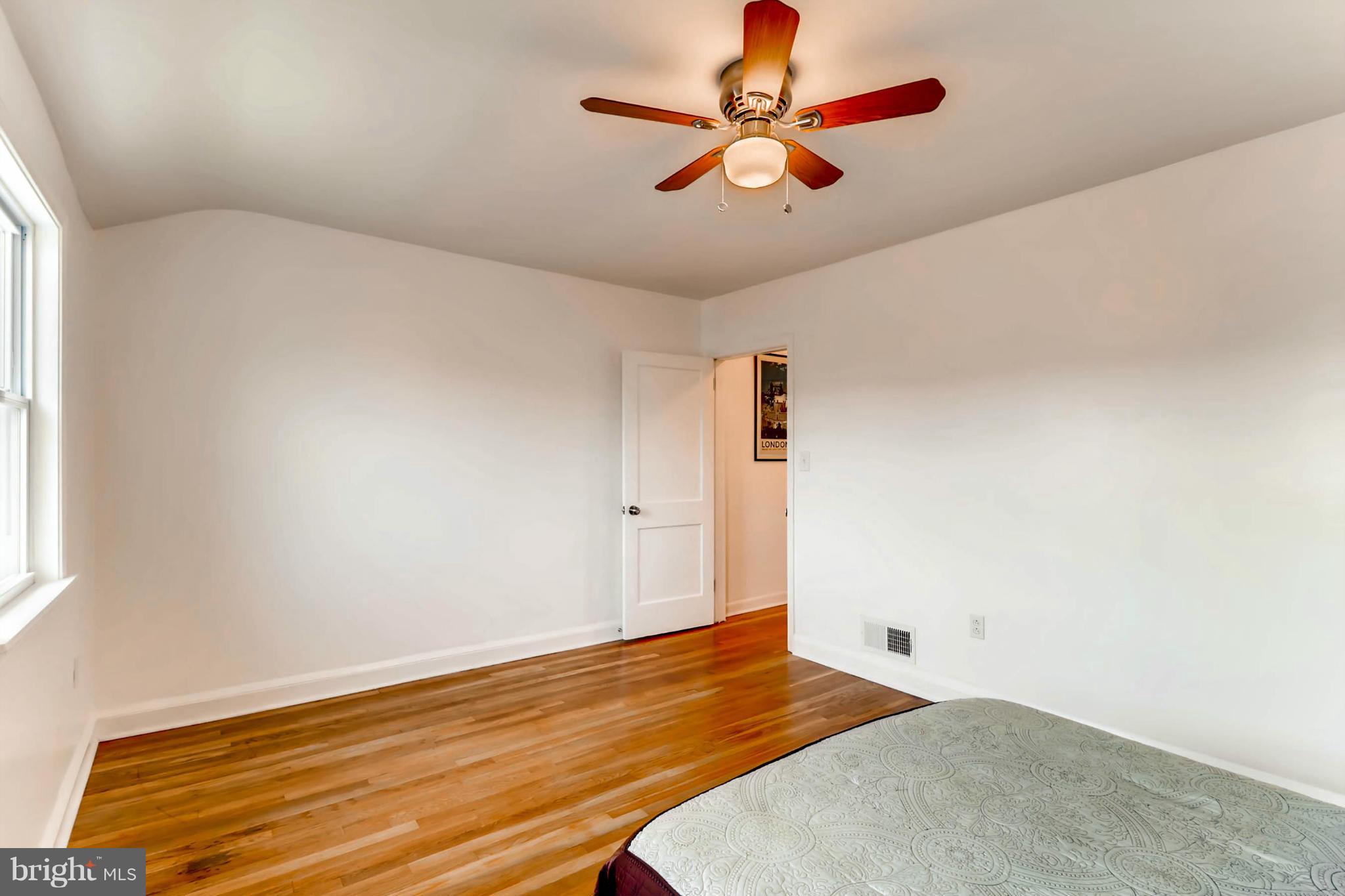 8405 Kavanagh Road Baltimore, MD 21222 - Photo 28 of 30 an empty room with wooden floor and windows