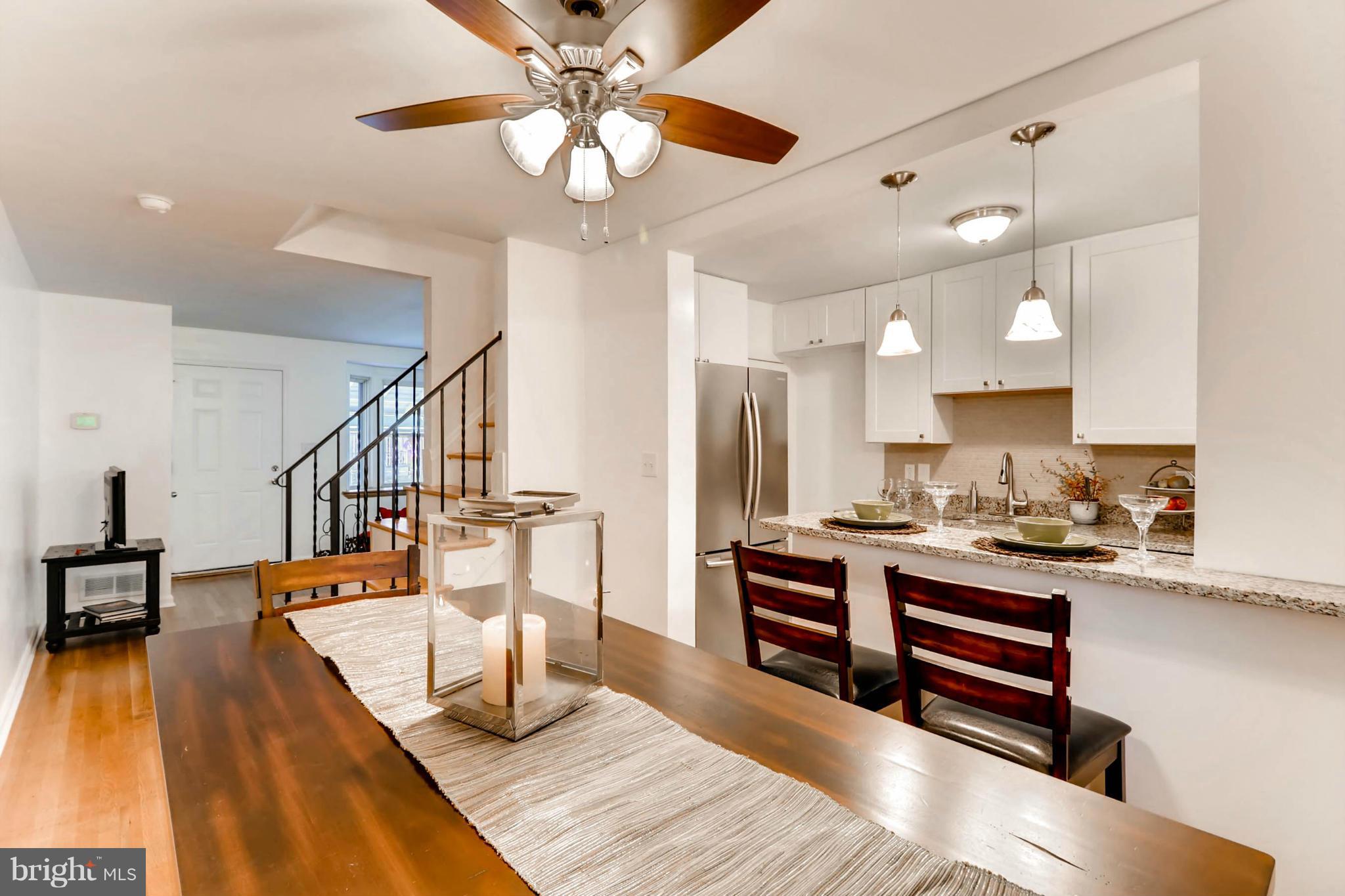 8405 Kavanagh Road Baltimore, MD 21222 - Photo 5 of 30 a living room with stainless steel appliances furniture a chandelier and a view of kitchen