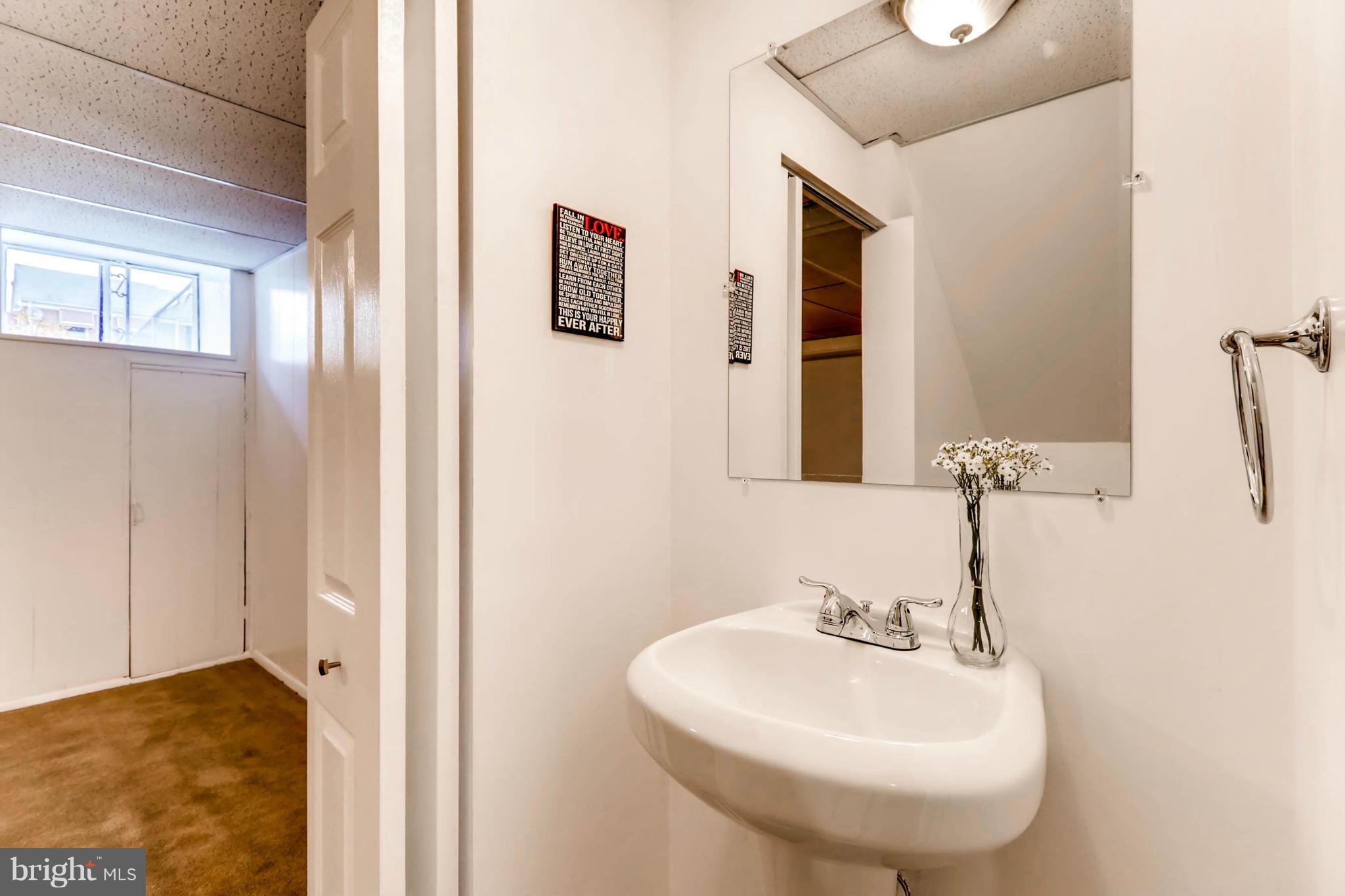 8405 Kavanagh Road Baltimore, MD 21222 - Photo 8 of 30 a bathroom with a sink and a mirror