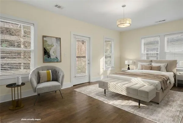 a spacious bedroom with a bed and a couch