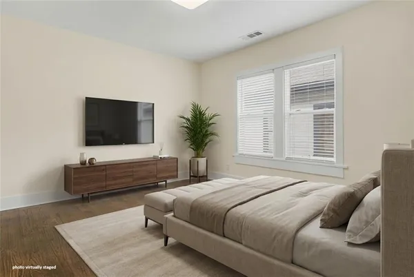 a bedroom with a bed and flat screen tv