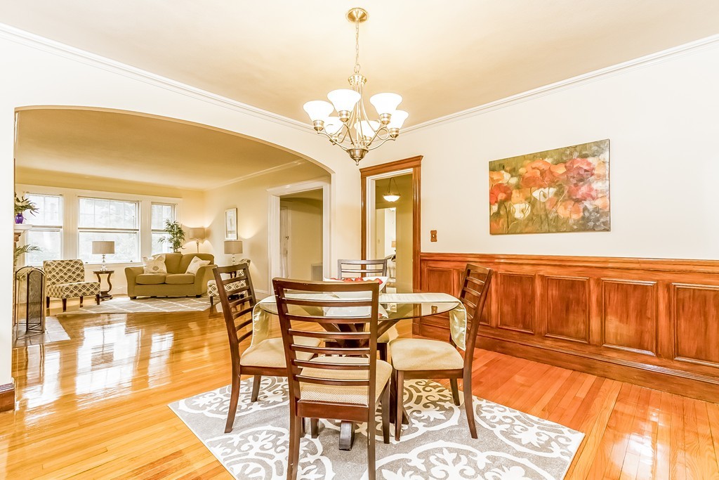 20 Buckminster Road, Unit 1 Brookline, MA 02445 - Photo 4 of 16 a dining room with wooden floor and large windows