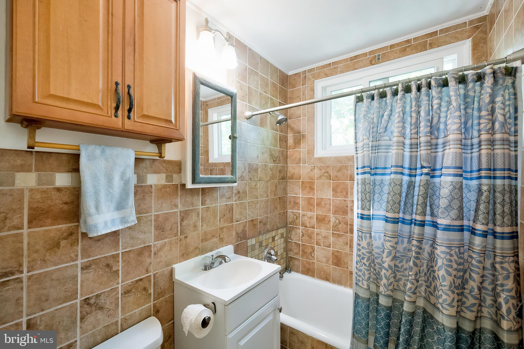71 Ridge Road Greenbelt, MD 20770 - Photo 14 of 24 a bathroom with a shower and a sink