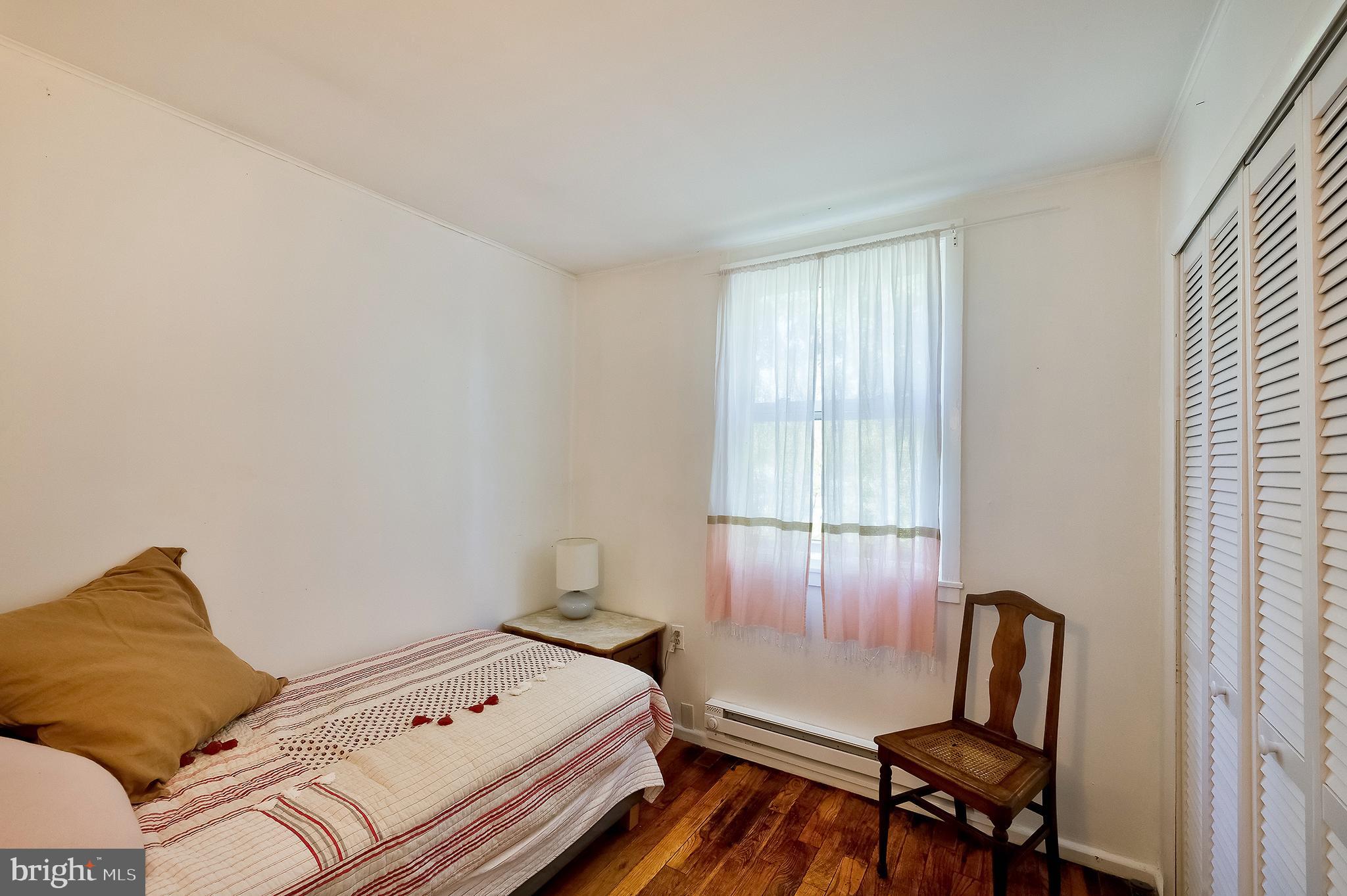 71 Ridge Road Greenbelt, MD 20770 - Photo 15 of 24 a bedroom with a bed and a window