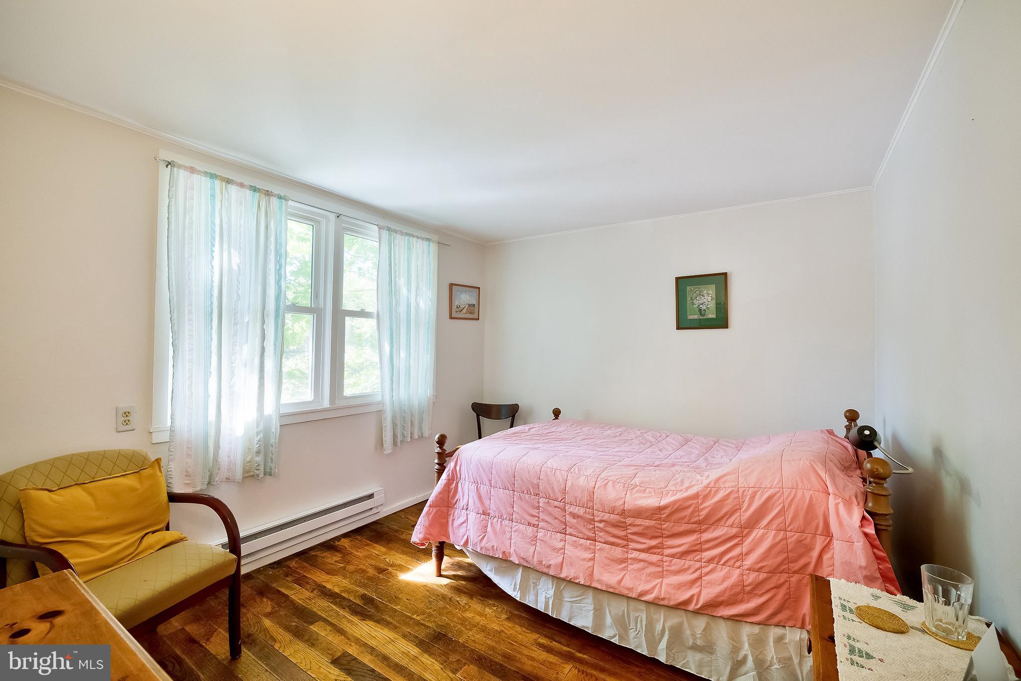 71 Ridge Road Greenbelt, MD 20770 - Photo 19 of 24 a bedroom with a bed chair and window