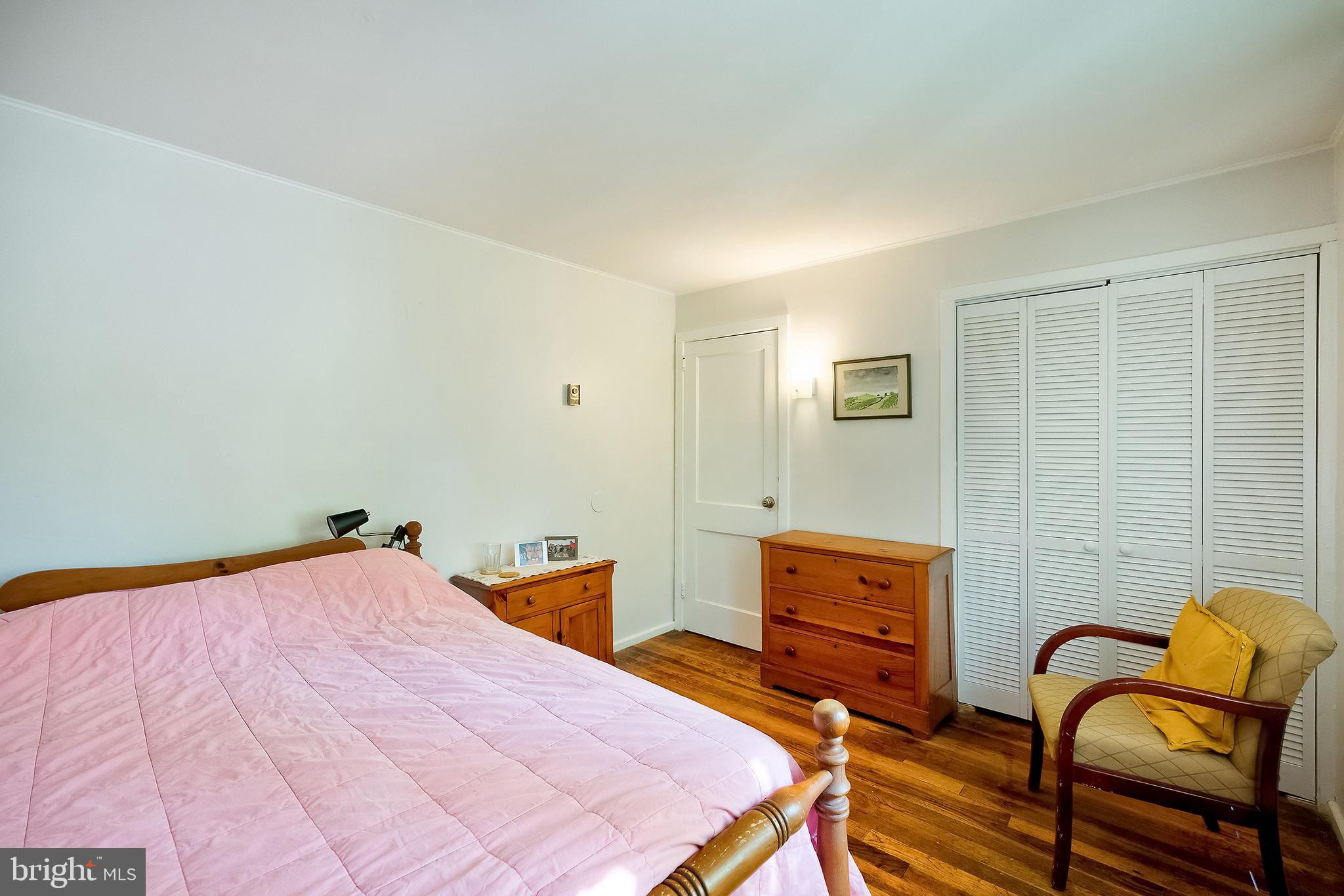 71 Ridge Road Greenbelt, MD 20770 - Photo 20 of 24 a bedroom with a bed and wooden floor