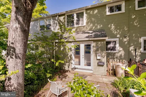 a front view of a house with outdoor seating