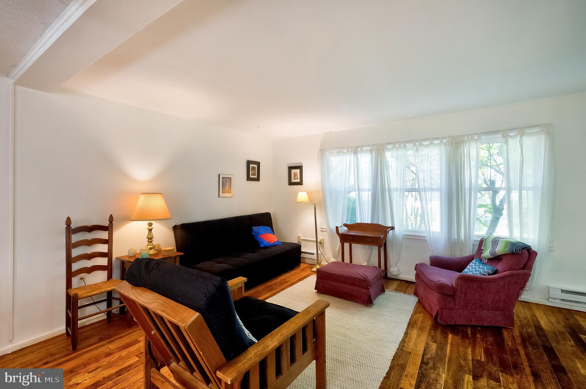 71 Ridge Road Greenbelt, MD 20770 - Photo 9 of 24 a living room with furniture a window and a lamp