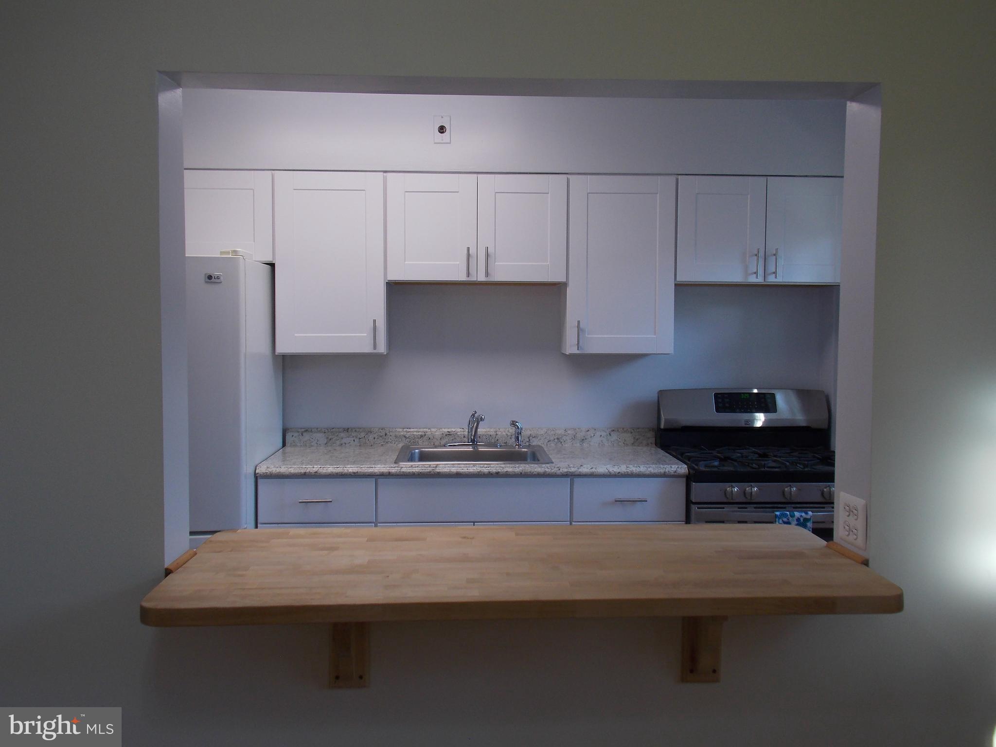 7713 Wynbrook Road Baltimore, MD 21224 - Photo 12 of 18 Opening from dining room to kitchen