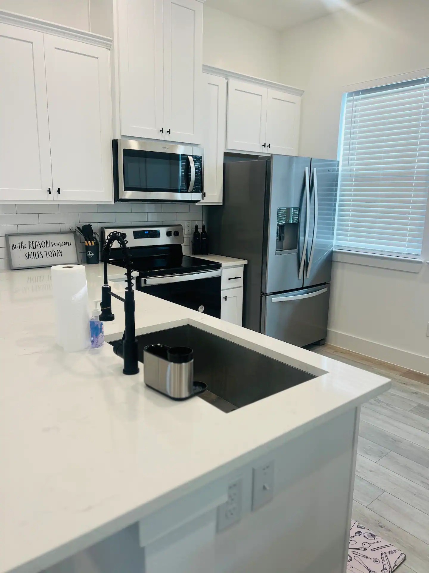8508 Wileyvale Road, Unit B Houston, TX 77016 - Photo 2 of 16 a kitchen with stainless steel appliances a refrigerator a stove a microwave and cabinets