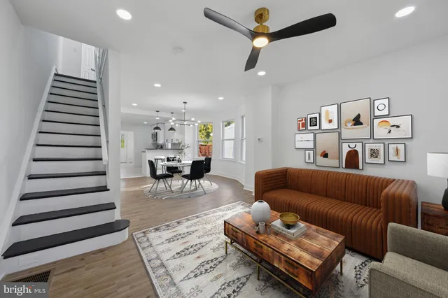 a living room with furniture and wooden floor